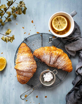 ￼Tasty croissant and tea for perfect breakfast